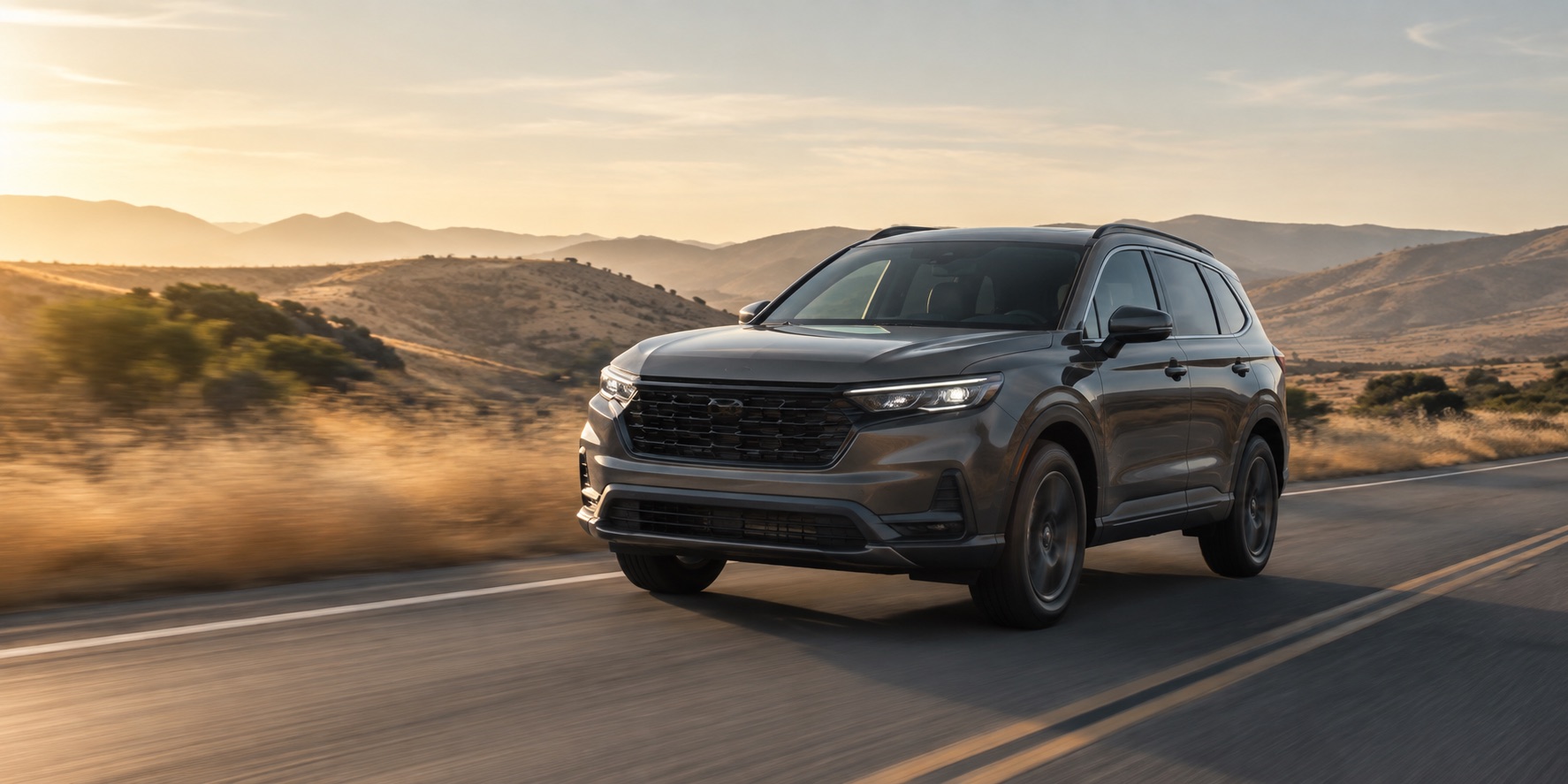 Charcoal SUV driving through Southern California hills at sunset